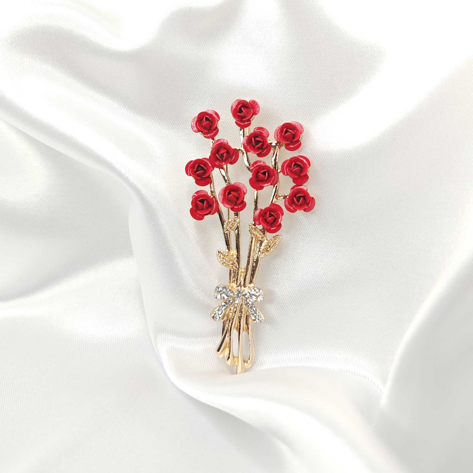 Photo de face de la broche bouquet de rose rouge et tige dorée