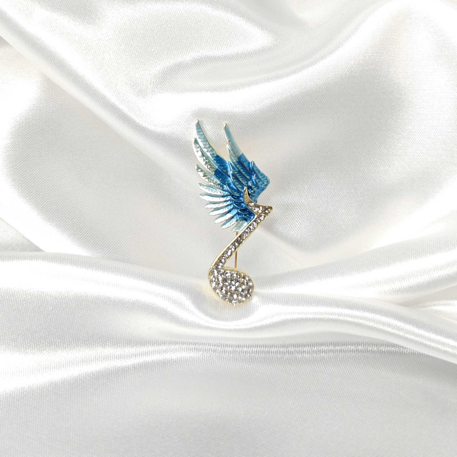 Broche bijou note musique ailée