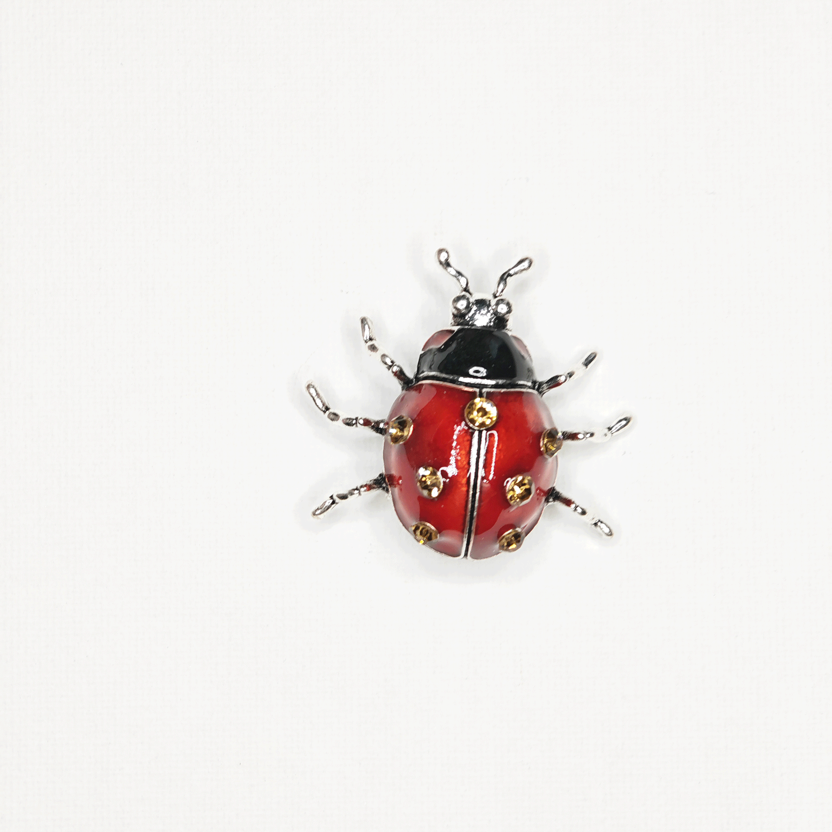 Broche bijou coccinelle rouge strass blanc, acier doré Broche bijou coccinelle rouge strass blanc, acier doré