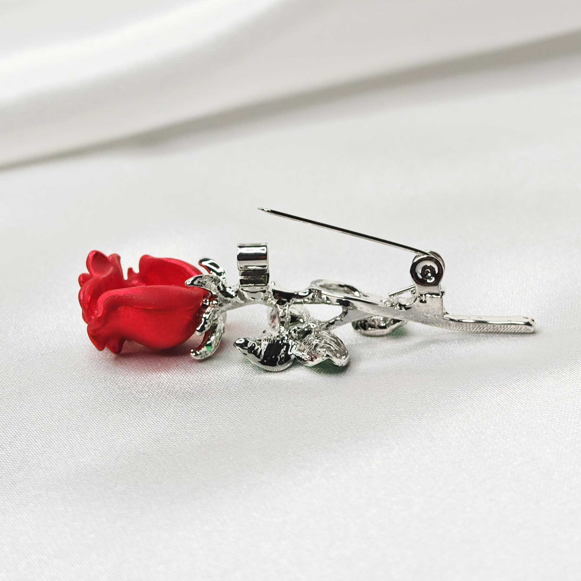 Photo vue zoom sur l'épingle à nourrice position ouverte de la broche rose rouge