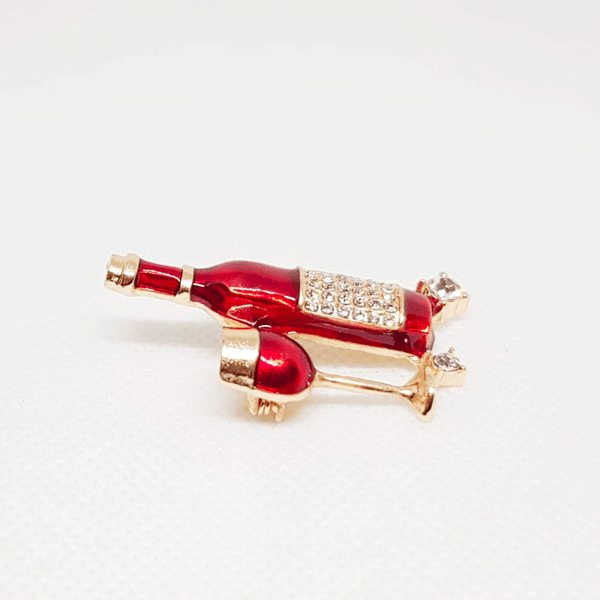 Golden Brooch Red Wine Bottle and Glass