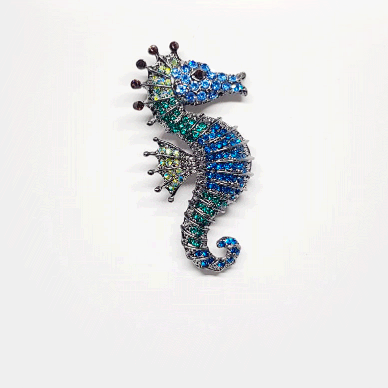 Broche hippocampe argente et strass bleus.